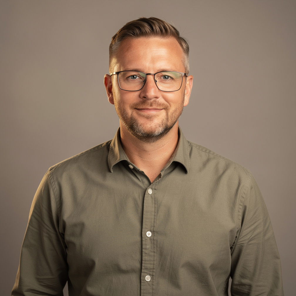 Studio portrait of a white man workflow engineer with glasses